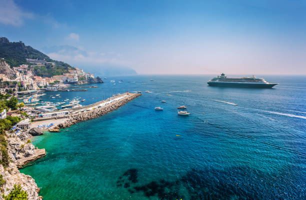 A view of clear blue water and white stucco buildings on a Greek island.